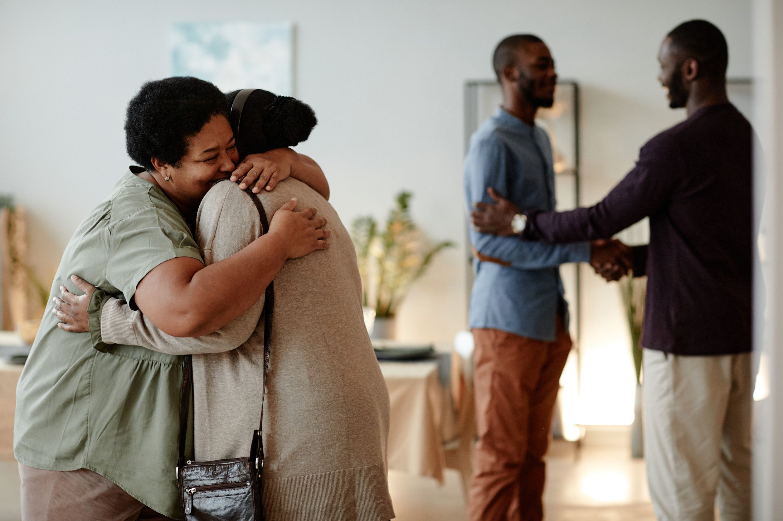 Side View At African American Family Welcoming Guests
