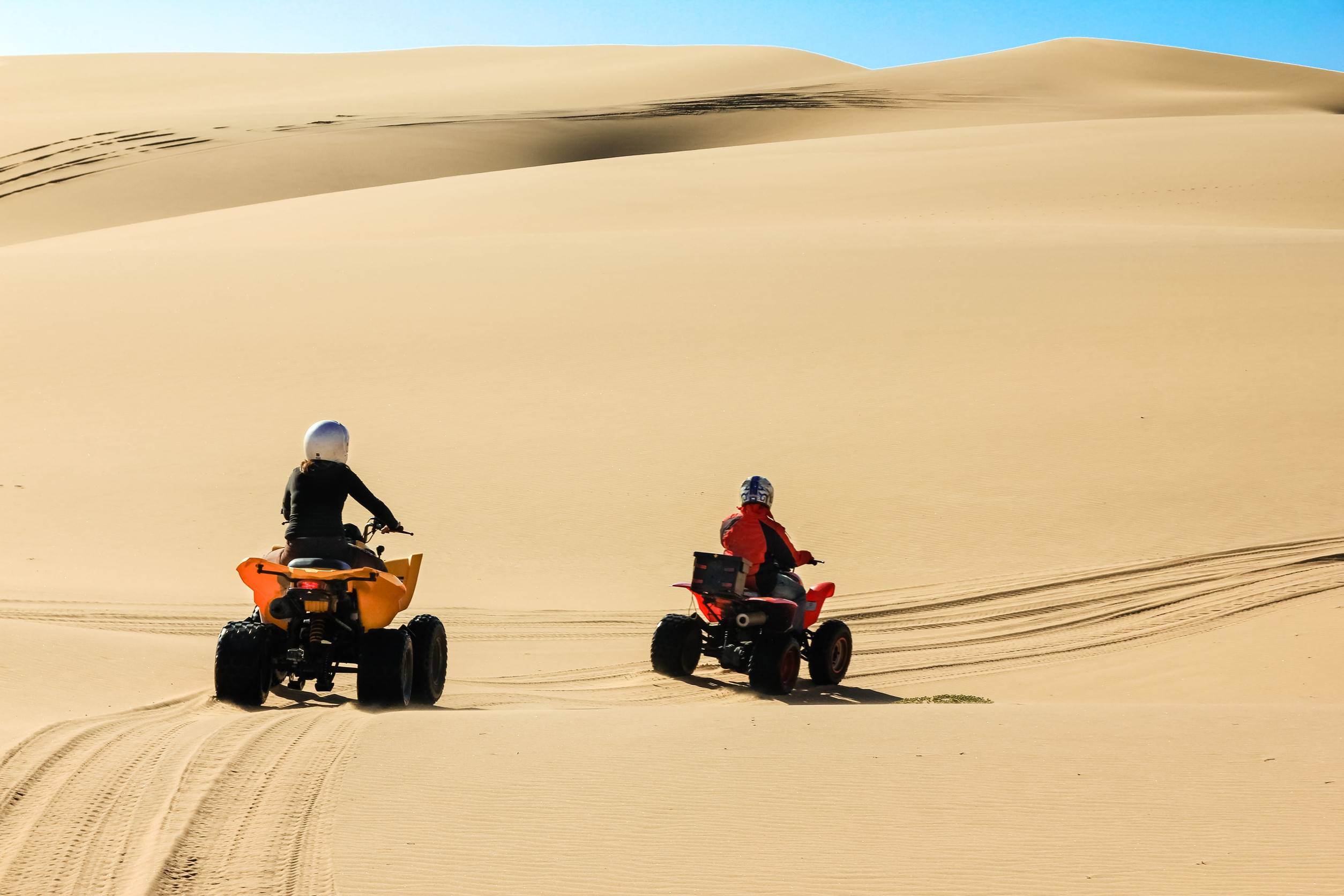 Two people driving quad bikes in Swakopmund